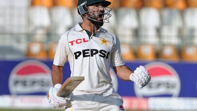 Pakistan's Kamran Ghulam celebrates after scoring a century. AP