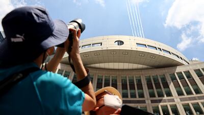 People take photos of the Japan air force aerobatic squadron Blue Impulse.