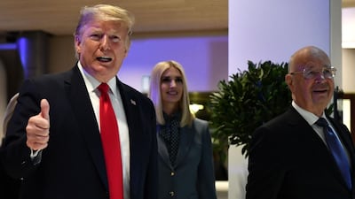 US president Donald Trump gestures flanked by his daughter White House Senior Advisor Ivanka Trump and World Economic Forum (WEF) founder and executive chairman Klaus Schwab, as they arrive at the Congress center during the World Economic Forum (WEF) annual meeting in Davos. AFP