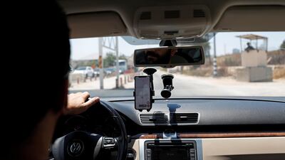 Mohammad Abdel Haleem, Chief Executive Officer of Doroob Technologies, uses Doroob Navigator application as he drives his car at an Israeli checkpoint in Ramallah, in the Israeli-occupied West Bank July 31, 2019. Reuters