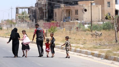 A displaced family returns to their home in Tikrit in June 2015, two months after Saddam Hussein’s hometown was taken back from ISIL. Hadi Mizban/AP Photo