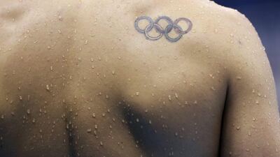 An unidentified athlete sports a tattoo with the Olympic rings during a swimming training session before the 2016 Rio Olympics in Rio de Janeiro, Brazil, Tuesday, August 2, 2016. Dmitri Lovetsky / AP Photo