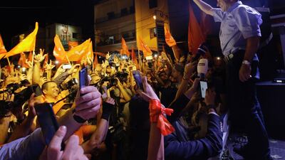 Free Patriotic Movement leader Gebran Basil celebrates on stage with supporters after the party's results in the parliamentary elections, early on May 7, 2018 in the Lebanese coastal town of Batroun. Ibrahim Chalhoub / AFP