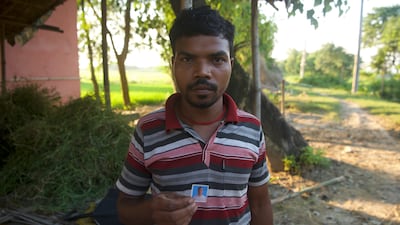 Pappu Kumar Soren with a photograph of his father Jarilal Soren, 60, who was killed by a snakebite this year. Mr Soren was outside his home in Singhia near Purnea when he was attacked