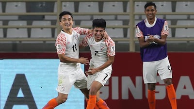 India's forward Sunil Chhetri, left, and midfielder Anirudh Thapa, right, celebrate their third goal during the AFC Asian Cup Group A match between Thailand and India in Abu Dhabi. AP