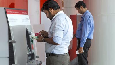 The amount of cash flowing into banks and consequently the amount they are willing to lend may reduce next year because of retreating crude prices. Mona Al Marzooqi / The National