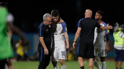 Christian Pulisic of the United States, No 10, is comforted after their 2-1 defeat to Trinidad and Tobago in October 2017. Rebecca Blackwell / AP Photo