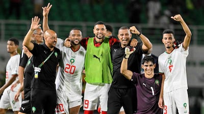 Morocco's players celebrate with assistant coach Rachid Benmahmoud after victory at the end of the Afcon match against Zambia in San Pedro. AFP