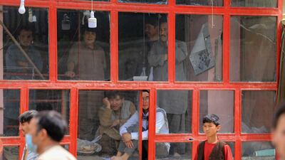 People look on from inside a building in the aftermath of multiple bomb blasts outside a school in a Shi'ite majority neighborhood in Kabul, Afghanistan. EPA