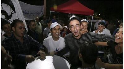 Ennahda party supporters dance during a rally near Tunis.