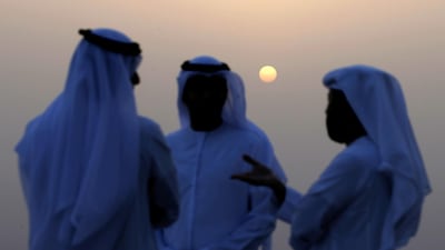 Men gather trying to sight the new crescent moon in Al Ain. EPA