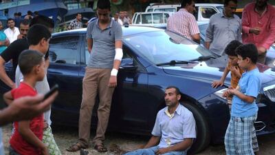 People gather along the shore of the Mediterranean Sea during a search for victims after a migrant boat capsized, in Al Beheira, Egypt, September 21, 2016. REUTERS/Stringer