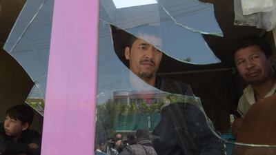 Afghan residents inspect the site of a suicide bombing outside a voter registration centre in Kabul on April 22, 2018. Shah Marai / AFP