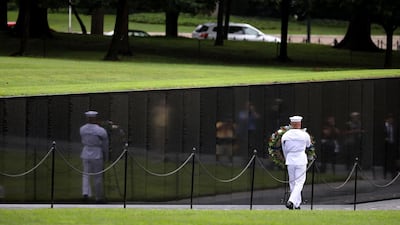 A US Navy seaman carries a wreath into the Vietnam Veterans Memorial before a ceremony to honour Mr McCain. Getty Images/AFP