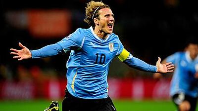 Diego Forlan, seen here scoring for Uruguay against Holland at the World Cup, has a wealth of experience in club and international football.