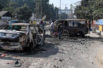 Burnt vehicles block a road in Guwahati, capital of India's Assam state, on December 13, 2019, a day after protests against the government's Citizenship Amendment Bill broke out across the north-eastern state. AFP