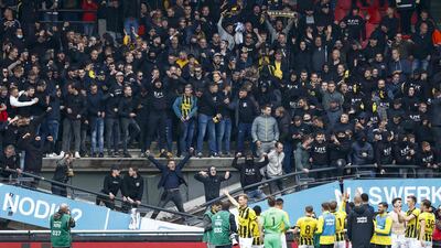 Vitesse Arnhem players salute their supporters as they stand on a collapsed stand after the Dutch Eredivisie match against NEC Nijmegen. AFP