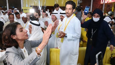 Alia Al Khaled, left, celebrates with her supporters after becoming one of two women elected to Kuwait's parliament in elections held on September 29. AFP