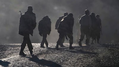 Ethnic Armenian soldiers walk along the road near the border between Nagorno-Karabakh and Armenia in November 2020. AP