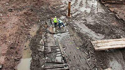 Archeologists take measurements of the wood hull of a ship, believed to be from the 18th century, at the World Trade Center site yesterday.