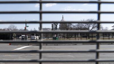 The US Capitol building seen through a mesh security fence. Willy Lowry / The National