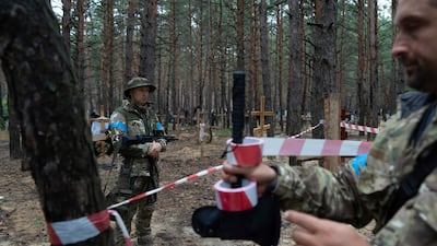 A mass grave containing the bodies of Ukrainian soldiers and civilians was found in the forest near the recently recaptured city of Izium. AP