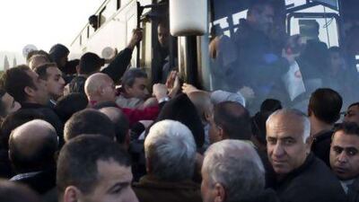 Palestinians board a Palestinians-only bus at the Eyal checkpoint, near the West Bank town of Qalqilya, on Monday. Menahem Kahana / AFP