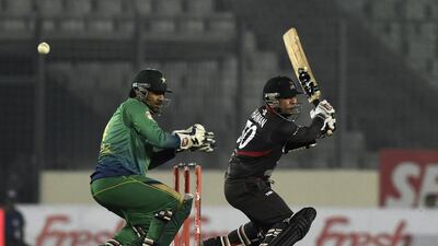 UAE's Shaiman Anwar, right, plays a shot as the Pakistan wicketkeeper Sarfraz Ahmed looks on during the Asia Cup T20 cricket tournament match at the Sher-e-Bangla National Cricket Stadium in Dhaka on February 29, 2016. AFP / MUNIR UZ ZAMAN