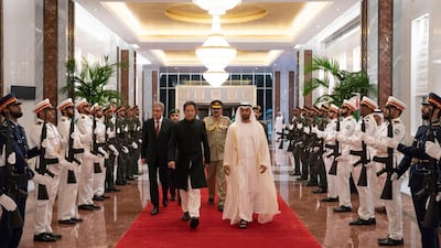 Sheikh Mohammed bin Zayed, right, walks with Pakistani Prime Minister Imran Khan, left, on his arrival in Abu Dhabi in September. Mohamed al-Hammadi / Crown Prince Court - Abu Dhabi