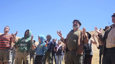 The congregation prays at the end of the special mass celebrated on the mountain every August to mark the transfiguration of Jesus Christ. Photo by Aram Abdo
