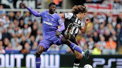 Emmanuel Adebayor, the Tottenham striker, competes for the ball with Fabricio Coloccini, the Newcastle centre-back, during their 2-2 draw at St James' Park. Michael Regan / Getty Images