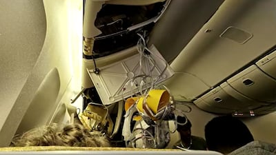 Oxygen masks dangle from the damaged cabin ceiling of Singapore Airlines flight 321 following heavy turbulence. Airlines are dealing with how to minimise turbulence risks after two extreme incidents last month. Reuters