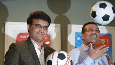 Sourav Ganguly, left, and Sanjiv Goenka, vice-chairman of RPG Enterprises, pose with footballs during a press conference to announce their ownership of the Kolkata franchise in the upcoming Indian Super League on April 14, 2014. Dibyangshu Sarkar / AFP
