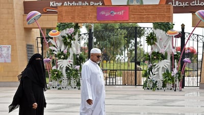 An elderly couple walk past the main gate of King Abdullah Park where a Yemeni man stabbed three performers during a live play in the Saudi capital Riyadh the previous day, according to police. AFP