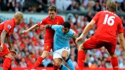 Carlos Tevez, centre, is surrounded by Joe Allen, who had such an impressive game in midfield, and Sebastian Coates, right, who started ahead of the experienced Jamie Carragher at the heart of Liverpool's defence. Paul Ellis / AFP