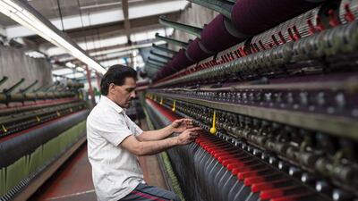 Abraham Moon & Sons is England's last vertical mill, where all manufacturing processes take place on one site – from raw wool through dyeing, blending, carding, spinning, warping weaving and finally finishing the fabrics. Oli Scarff / AFP