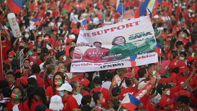 Supporters of Mr Marcos Jr and Sara Duterte, daughter of President Rodrigo Duterte and a vice presidential candidate, display a banner with their portraits during a campaign rally in Paranaque City. AFP
