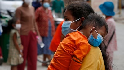 A woman walks outside a hospital in Phnom Penh, Cambodia. EPA