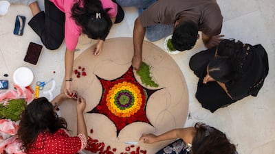 People prepare a pookalam, or athapookalam, an intricate floral carpet or design laid on entryways and floors during the traditional ten-day festival.