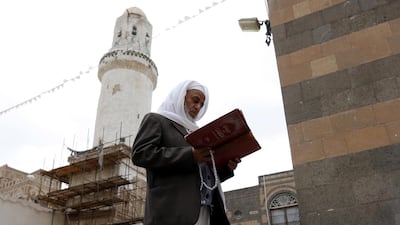 A Yemeni man reads the Quran at a mosque in Sanaa. EPA