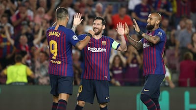 Barcelona's Lionel Messi celebrates with Luis Suarez and Arturo Vidal after scoring their fourth goal to complete his hat-trick. Reuters