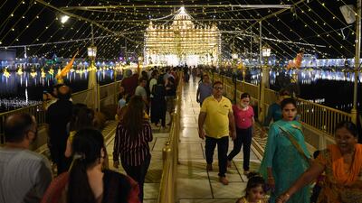 Devotees visit the illuminated Durgiana Temple in Amritsar. AFP