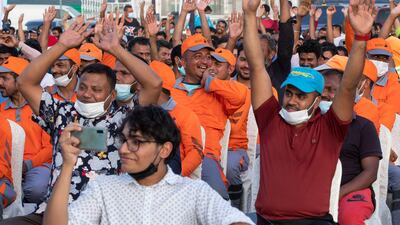 People cheer as dancers entertain the crowd.
