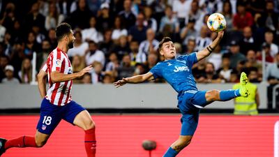 Juventus Paulo Dybala, right, stretches for the ball. AP Photo