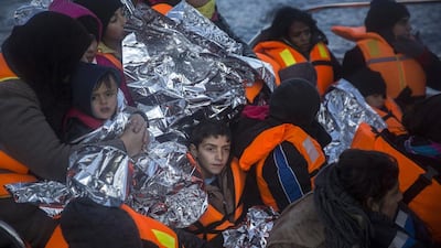 Refugees arrive on a vessel of Frontex, European Border Protection Agency, after their rescue near the Greek island of Lesbos. Santi Palacios / AP Photo