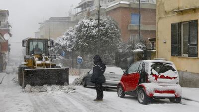 Snow is cleared from a street in the Camaldoli's Hill, over Naples, southern Italy. EPA