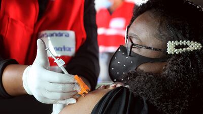 Ashia Rivers, 17, of Havre De Grace, Maryland, US gets her first dose of the Pfizer vaccine against the coronavirus while sitting in the back seat of her family car at the mass vaccination site at Ripken Baseball on May 05, 2021 in Aberdeen, Maryland, US. Getty Images/AFP