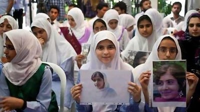School-children hold up posters in solidarity with Malala Yousufzai at the Embassy of Pakistan in Abu Dhabi, which held a tribute for the 14-year-old that was shot in the head by the Taliban in the SWAT valley a few days ago.