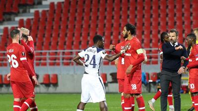 Tottenham's Serge Aurier, left, congratulates Royal Antwerp's Faris Haroun after Royal Antwerp won the Europa League match. AP