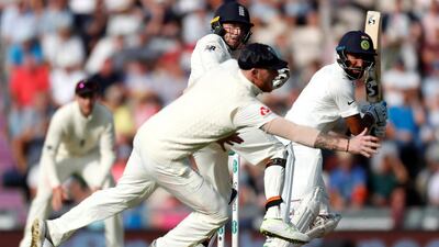 India's Cheteshwar Pujara hits a shot past England's Jos Buttler and Ben Stokes. Reuters